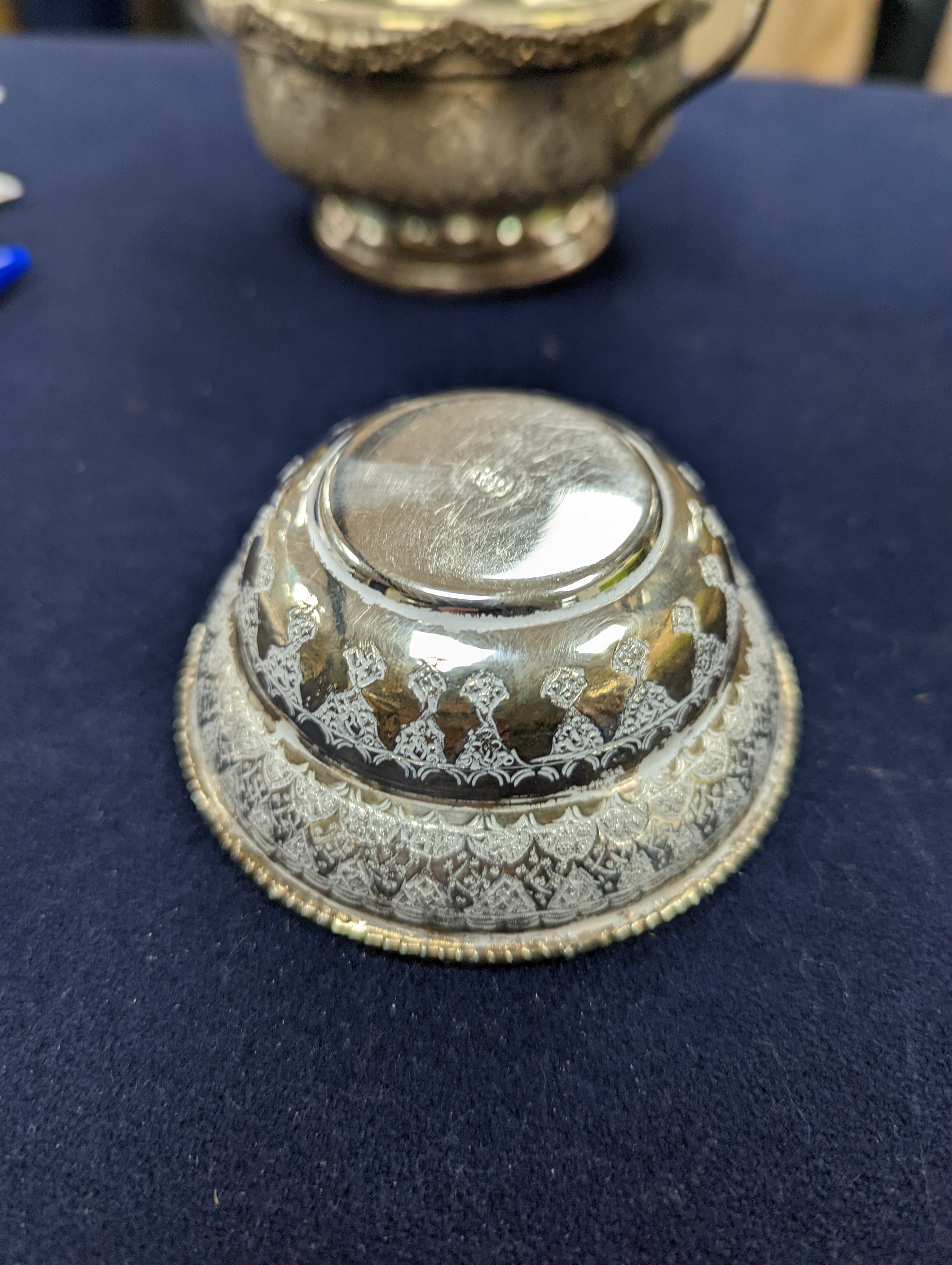 A set of six Persian embossed 84 standard white metal coffee cup holders and matching sugar bowl and cover by Vartan and four other Persian white metal items.
